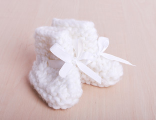 Knitted baby socks on against the backdrop