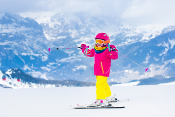 Little child skiing in the mountains