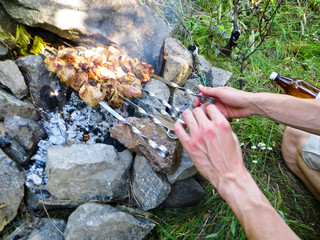 Preparing meat shish kebab (shashlik) on skewers