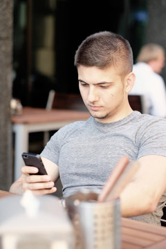 Man with mobile phone in restaurant