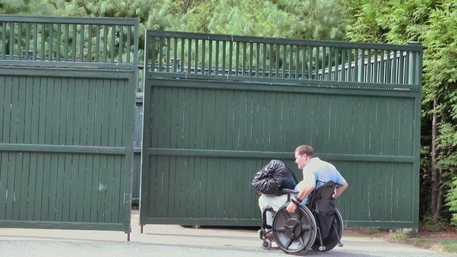Man in wheelchair going to the bin