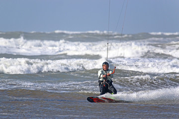 Fototapeta na wymiar kitesurfer riding in waves