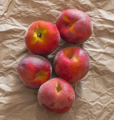 Group of Fresh Organic Peaches on a Craft Paper