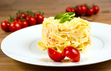 close-up of plate of pasta and smoked salmon with tomato