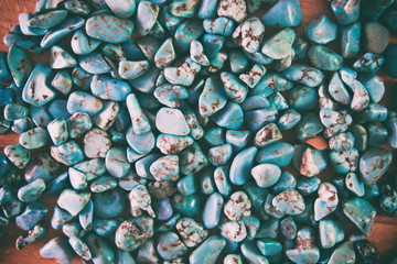 blue background, gemstone turquoise on a wooden background with
