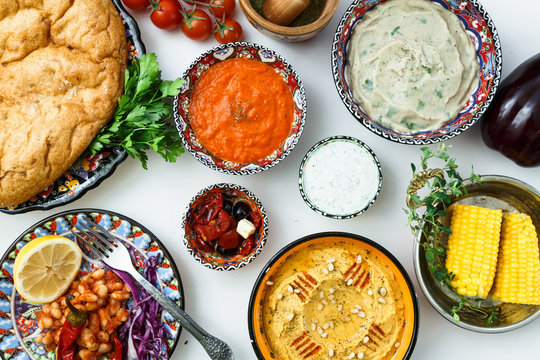 Mediterranean Traditional Meze: Hummus, Babaganoush, Harissa, Tzatziki On White Background