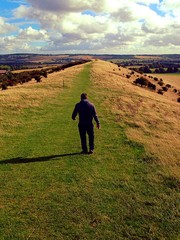 man walking on a hillside