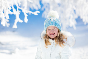 Child having fun in snowy winter park