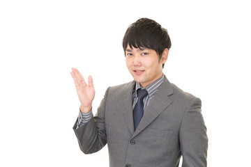 案内する笑顔のビジネスマン