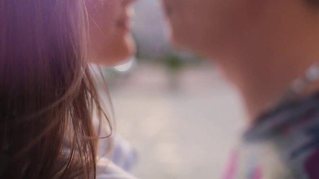 Couple kissing close up blur background.