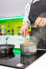 Man adding rosemary to meat