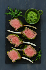Rack of lamb in herb cheese and breadcrumbs. A festive meal. Selective focus.