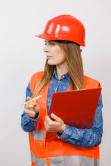 Woman engineer construction builder in helmet.