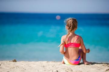 Fototapeta na wymiar Adorable little girl at tropical beach during vacation
