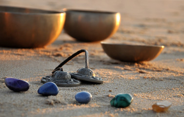 Singing bowls and instruments on beach