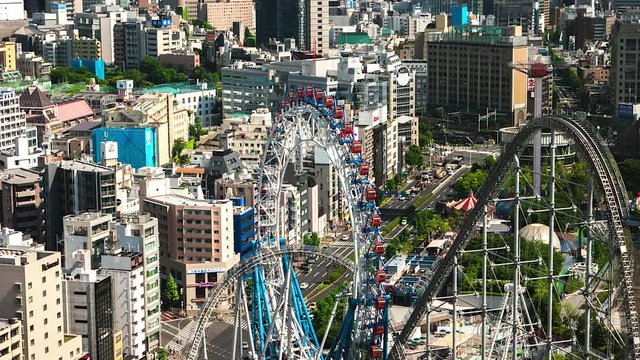Tokyo - Aerial view of city with ferris wheel, amusement park and traffic. May 2016. 4K resolution time lapse.