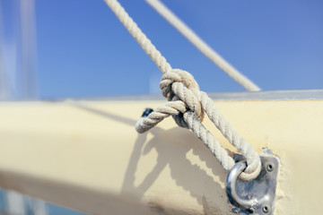 Fototapeta premium Closeup view of ship rope tackles on sunny blue sky background outdoors