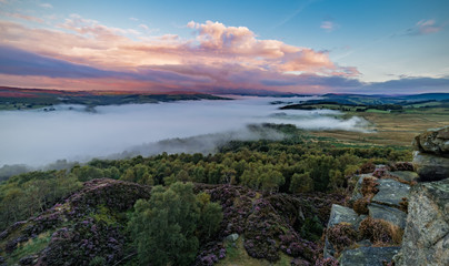 Morning Mist and Colourful Sunrise Clouds View From the Top of Owler Tor in Peak District 