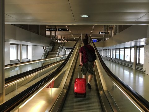 Man in the airport - mechanical stair