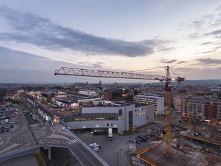Fototapeta na wymiar Aerial cityscape panorama view of building construction crane at sunset time. Krakow, Poland travel landscapes and destinations