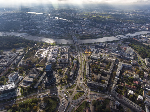 Aerial city view with crossroads and roads, river, buildings, intersections, houses, parks and parking lots, bridges. Panoramic image of Krakow, Poland