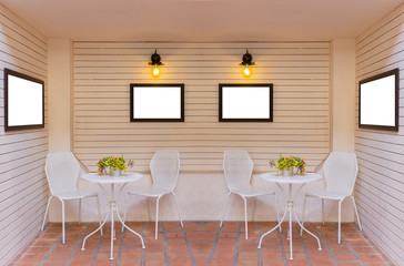 Tables, chairs, picture frames and wooden walls.