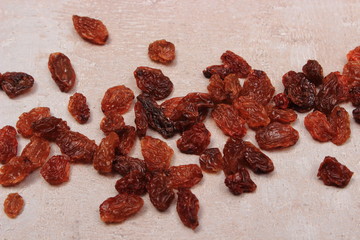 Brown raisins on structure of concrete, healthy eating