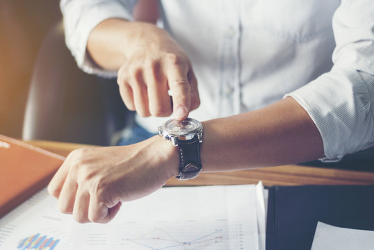 Businessman look his watch. Close-up hands.