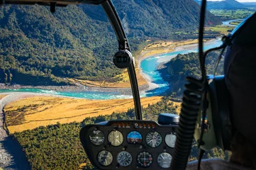Zelfklevend Fotobehang View from helicopter on beautiful landscape of mountain river. Whataroa, South Island, New Zealand. Selective focus on landscape © Olga K
