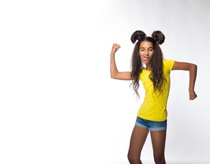 Emotional young brunette girl with long hair in yellow shirt on a white background
