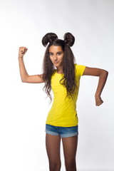 Emotional young brunette girl with long hair in yellow shirt on a white background