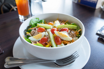 Tuna with vegetable salad in white bowl