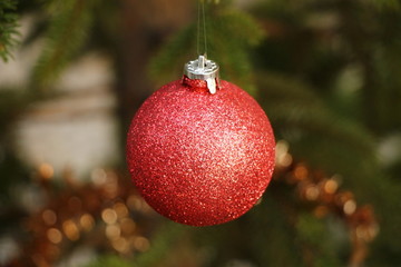 One red Christmas ball on Christmas tree