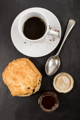sweet british raisin scone and a glass filled with honey