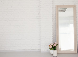 room with brick wall and mirror in a beautiful frame