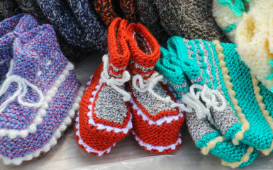 Fototapeta na wymiar handmade knitted wool baby socks for sale