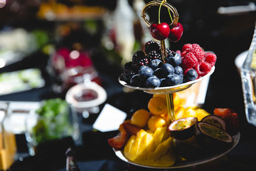 Fototapeta na wymiar Tasty berries and exotic fruits lie on the layered dish