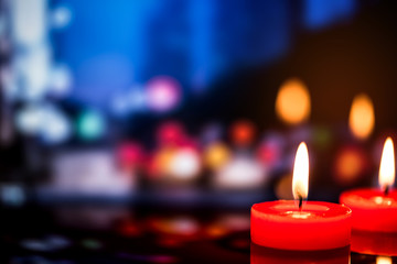 still life red candle light with reflection on dark stone ,abstract background for pray or meditation caption.
