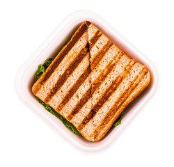 Hot sandwich in a plastic bowl on white