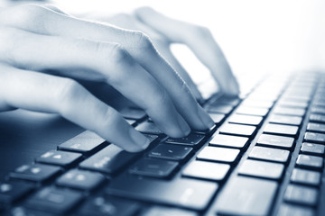 Woman typing on laptop