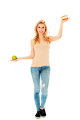 Young woman holding an apple and cookie