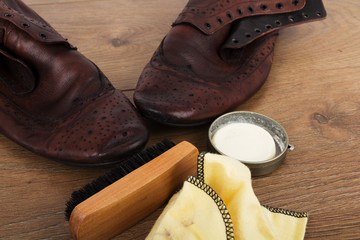Shoes and cleaning equipment on a wooden floor