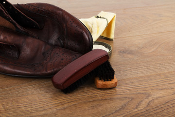Shoes and cleaning equipment on a wooden floor