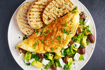 Mushroom, Feta Cheese egg Omelette witch Avocado, vegetables, lettuce, herbs and grilled bread.