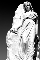 White statue of lady in cemetery