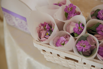 Pink and violet petals put in white envelopes