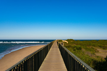 Fototapeta na wymiar Wooden footpath along ocean coastline in Urunga, New South Wales