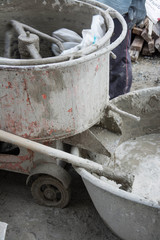 mixing ingredients in the concrete mixer at building site