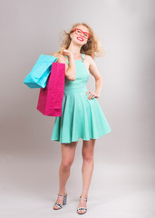 Smiling girl with the shopping bags, studio shot