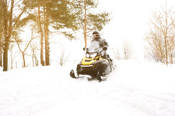 Man on snowmobile. Recreation concept on nature in winter holidays. Winter sports.